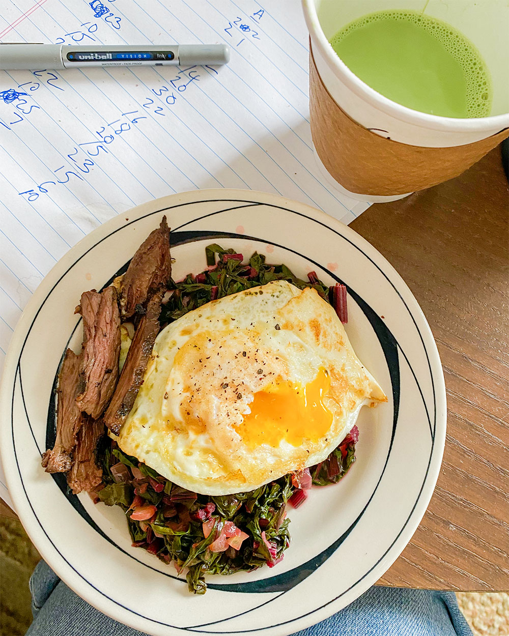 a plate of food with greens and an egg