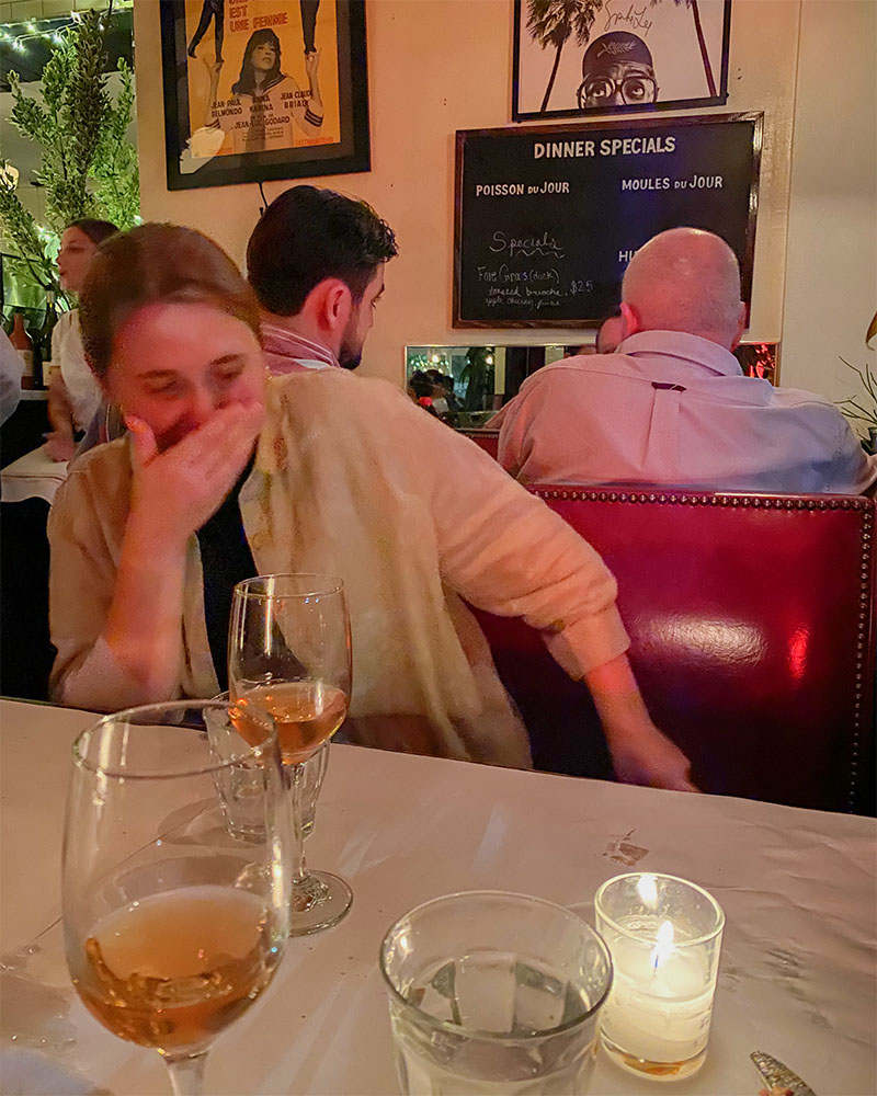 a picture of my sister laughing across the dinner table