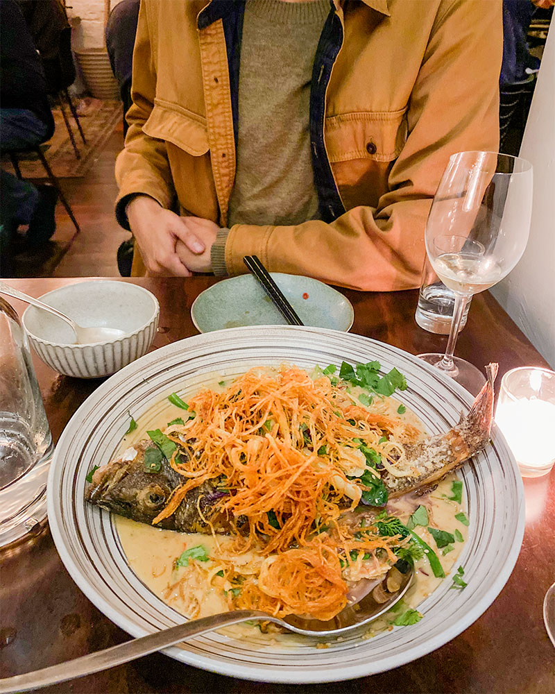 a dinner table with a plate of fish