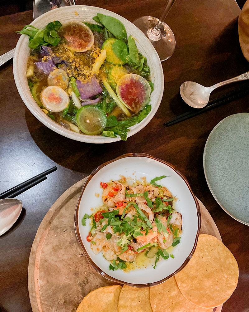 a dinner table with soup and an appetizer