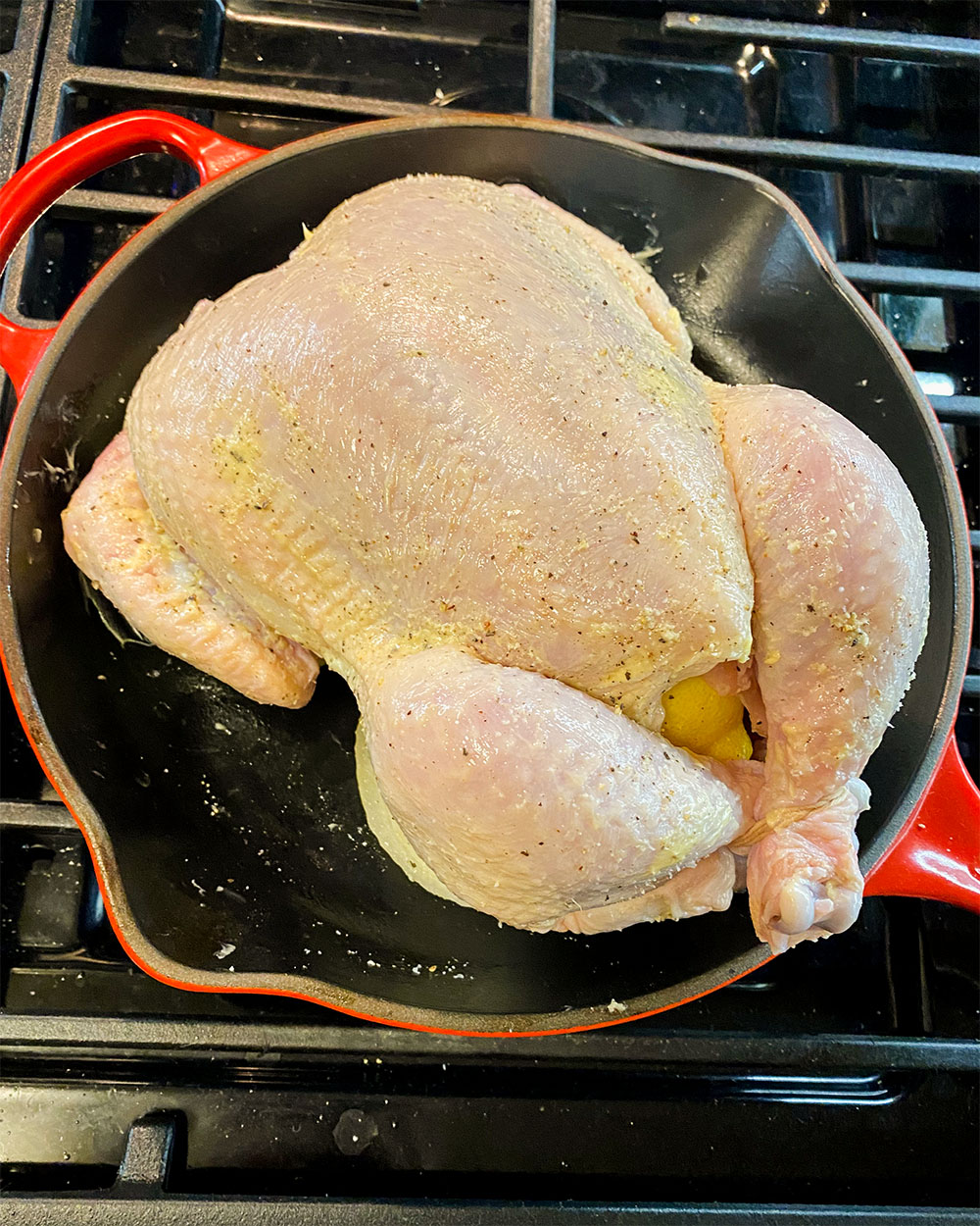 a whole raw chicken in a pan