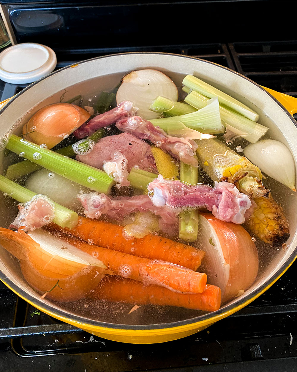 pot filled with vegetables and chicken pieces