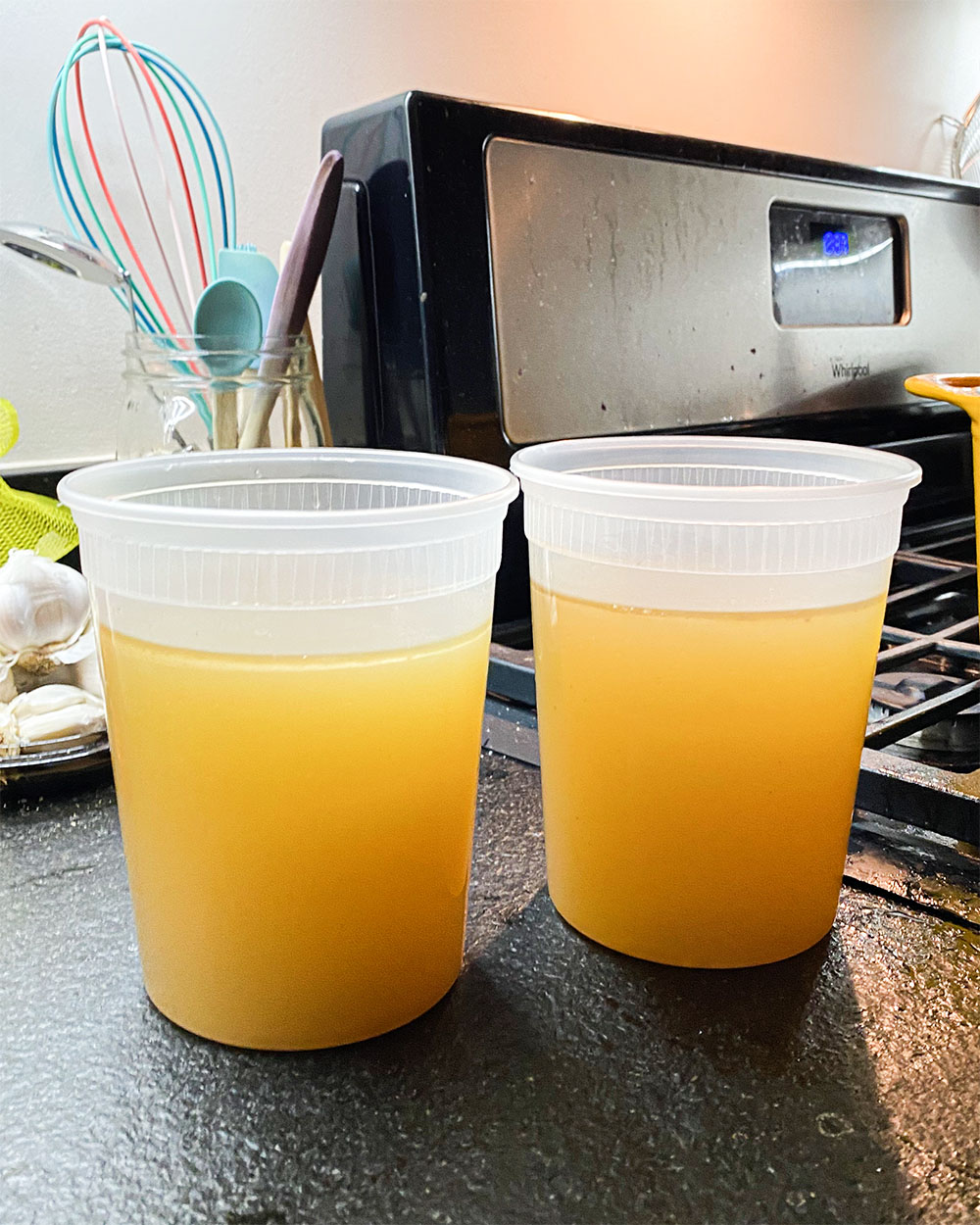 two quart containers filled with chicken broth